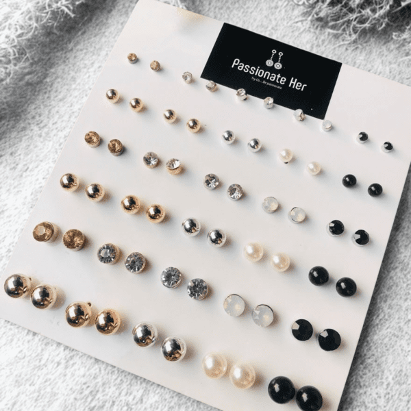 Stud earring set from Passionate Bangladesh, featuring multiple pairs of small everyday studs in different shapes and colors, budget friendly, attractive earrings and arranged on a display card.
