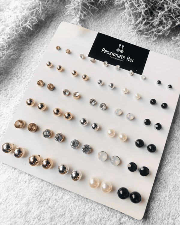 Stud earring set from Passionate Bangladesh, featuring multiple pairs of small everyday studs in different shapes and colors, budget friendly, attractive earrings and arranged on a display card.
