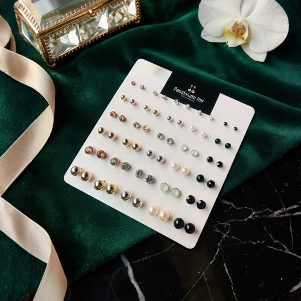 Stud earring set from Passionate Bangladesh, featuring multiple pairs of small everyday studs in different shapes and colors, budget friendly, attractive earrings and arranged on a display card.