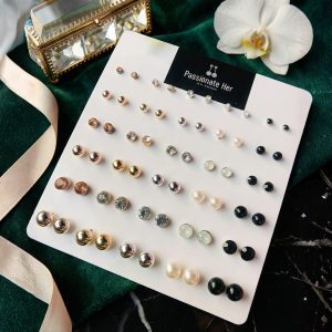 Stud earring set from Passionate Bangladesh, featuring multiple pairs of small everyday studs in different shapes and colors, budget friendly, attractive earrings and arranged on a display card.