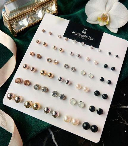 Stud earring set from Passionate Bangladesh, featuring multiple pairs of small everyday studs in different shapes and colors, budget friendly, attractive earrings and arranged on a display card.
