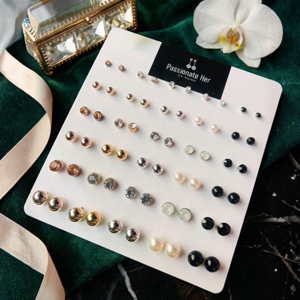 Stud earring set from Passionate Bangladesh, featuring multiple pairs of small everyday studs in different shapes and colors, budget friendly, attractive earrings and arranged on a display card.