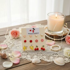 Stud earring set from Passionate Bangladesh, featuring multiple pairs of small everyday studs in different shapes and colors, budget friendly, attractive earrings and arranged on a display card.