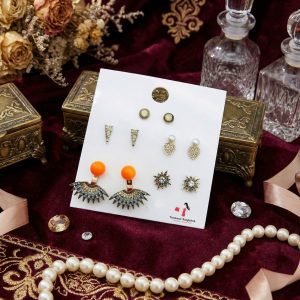 Stud earring set from Passionate Bangladesh, featuring multiple pairs of small everyday studs in different shapes and colors, budget friendly, attractive earrings and arranged on a display card.