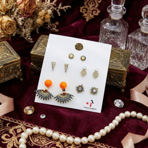 Stud earring set from Passionate Bangladesh, featuring multiple pairs of small everyday studs in different shapes and colors, budget friendly, attractive earrings and arranged on a display card.
