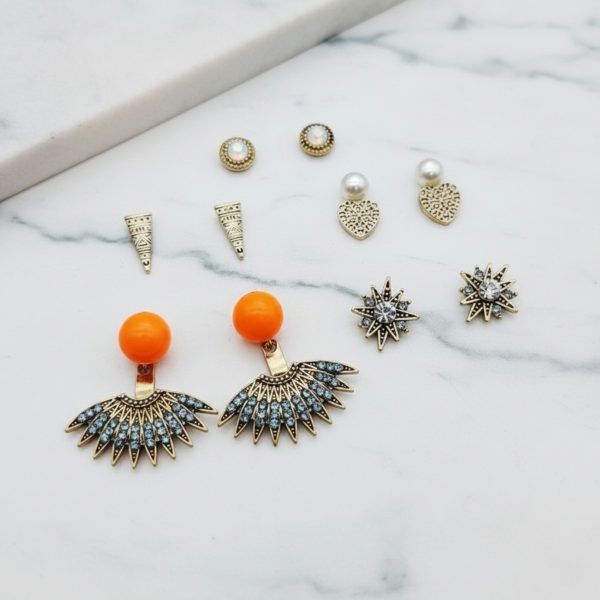 Stud earring set from Passionate Bangladesh, featuring multiple pairs of small everyday studs in different shapes and colors, budget friendly, attractive earrings and arranged on a display card.